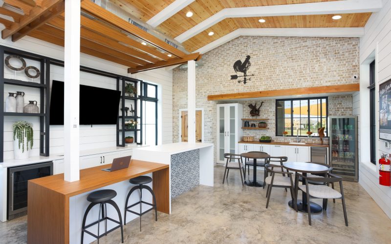 Inside the amenity center at Harvest Ridge with a bar, TV, and tables.