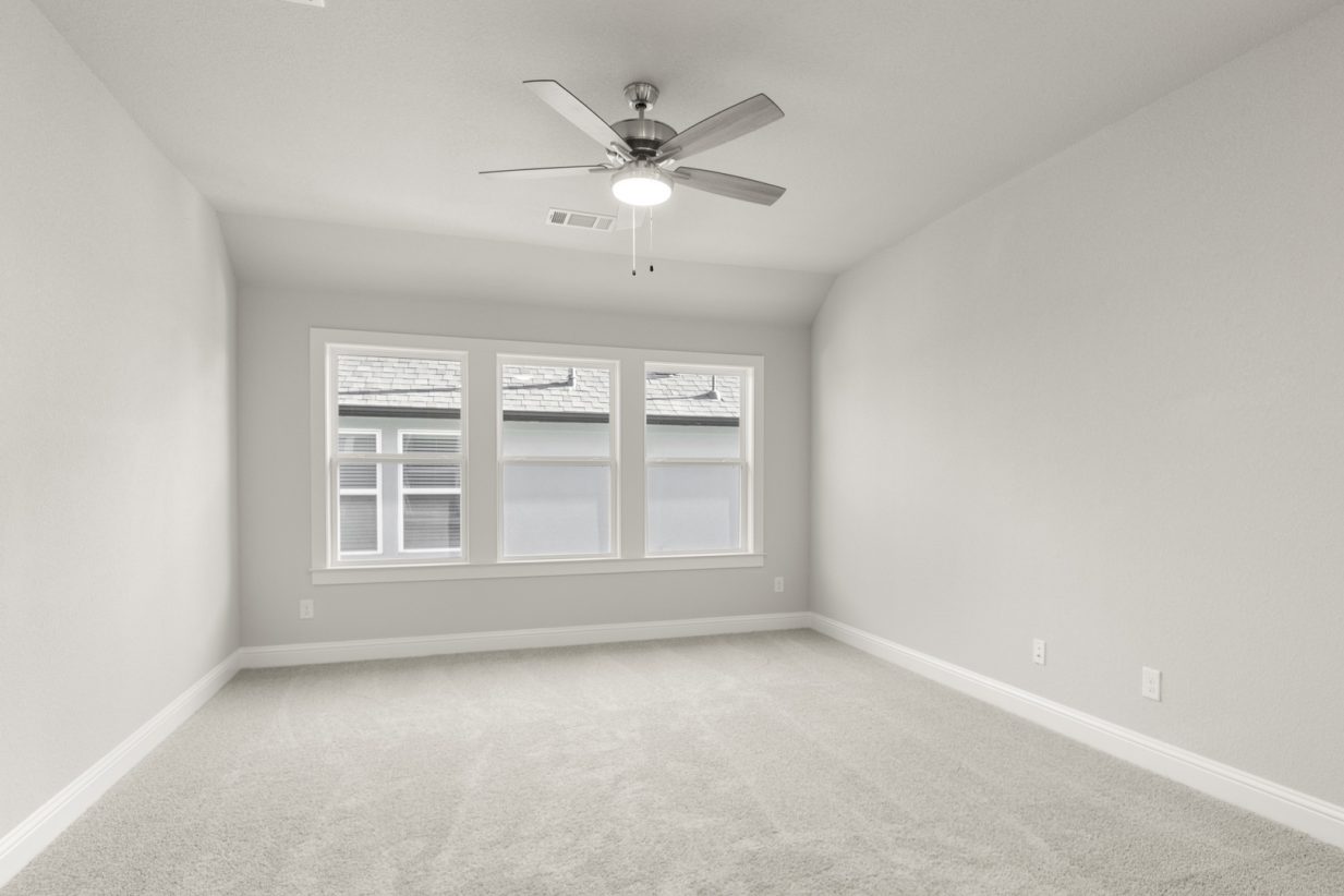 Image of a flex space with light grey carpeting and painted walls with three large windows