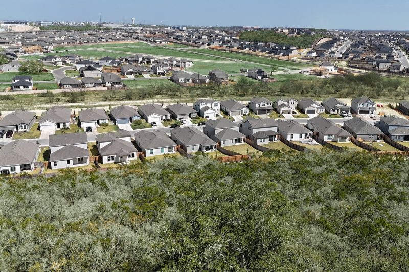 Aerial photo of community of homes with trees and green spaces