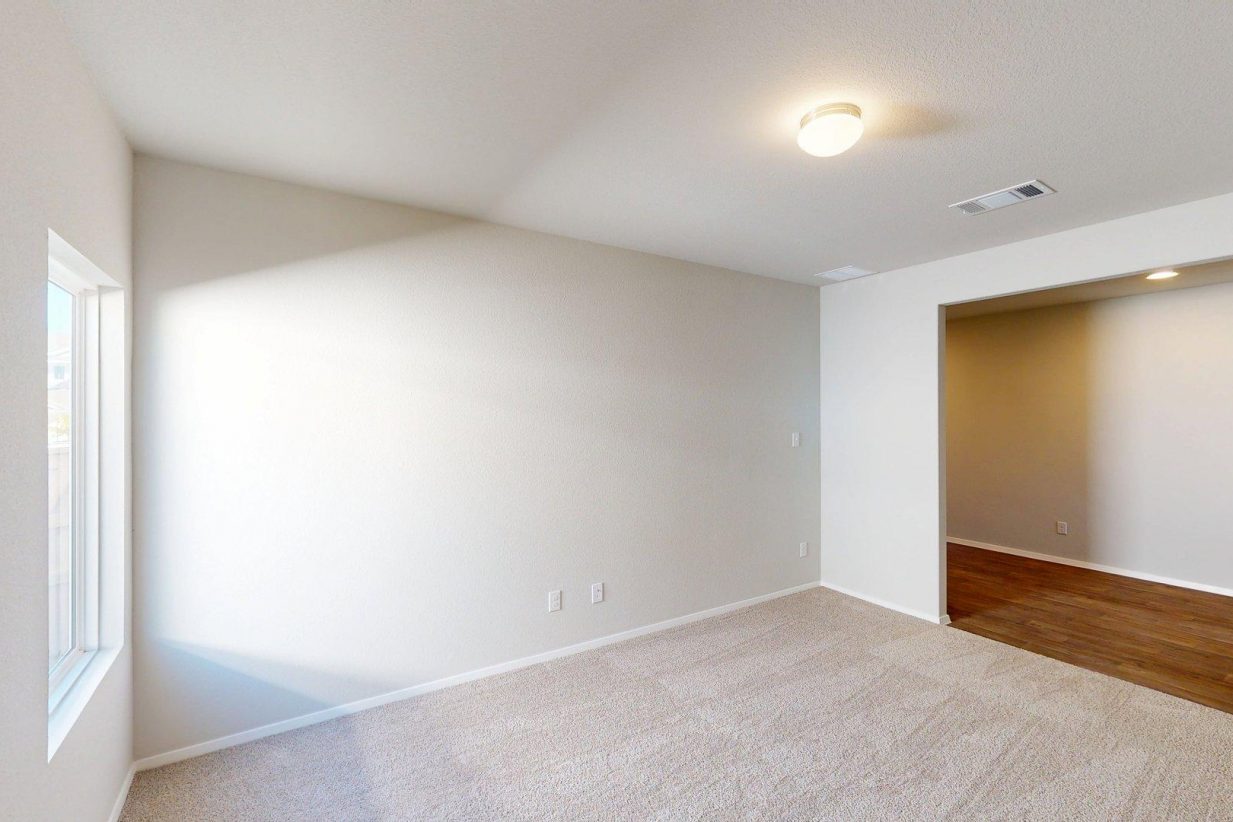 Image of a flex space area with tan carpeting and light grey walls
