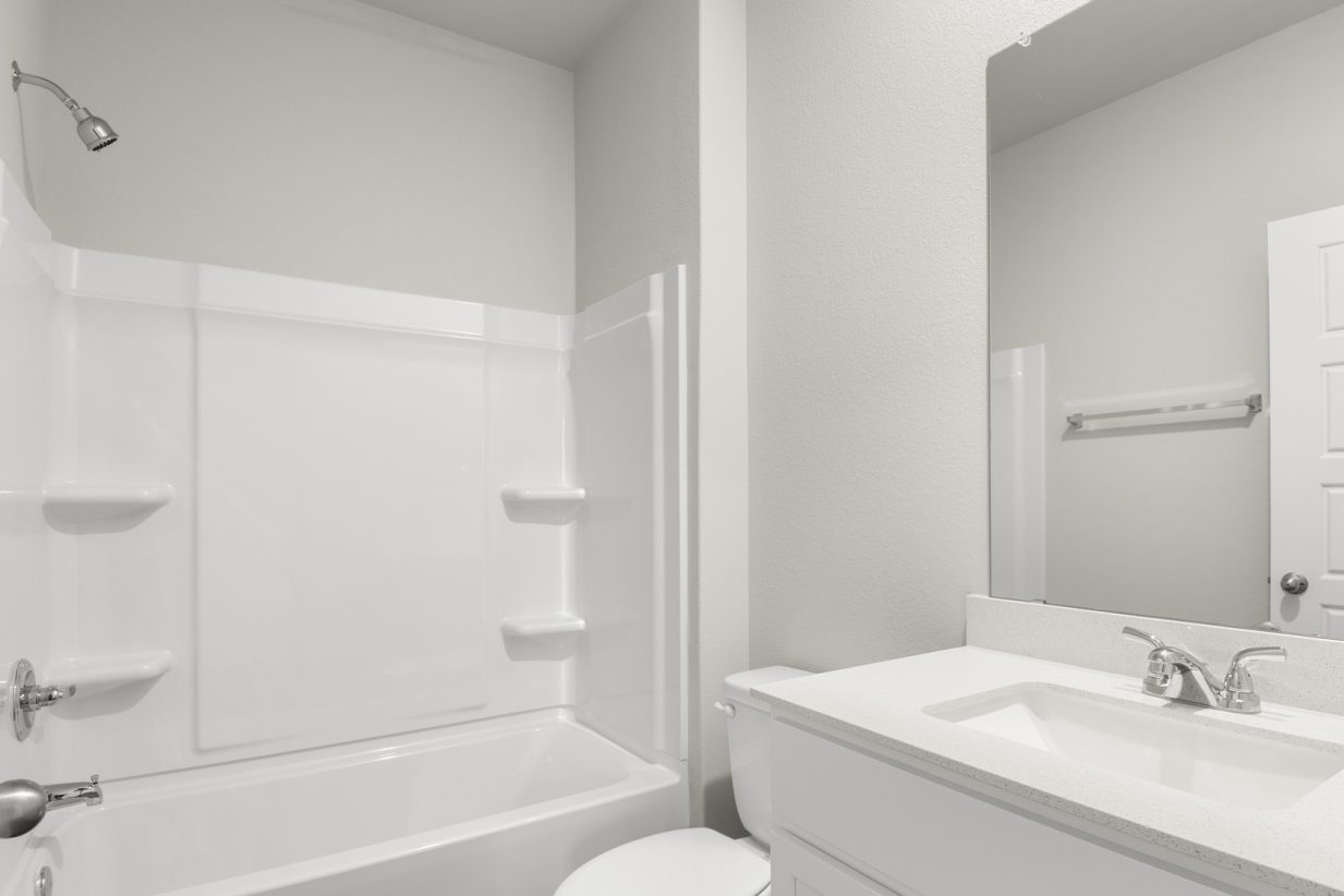 Image of bathroom with white cabinets and a shower with a tub