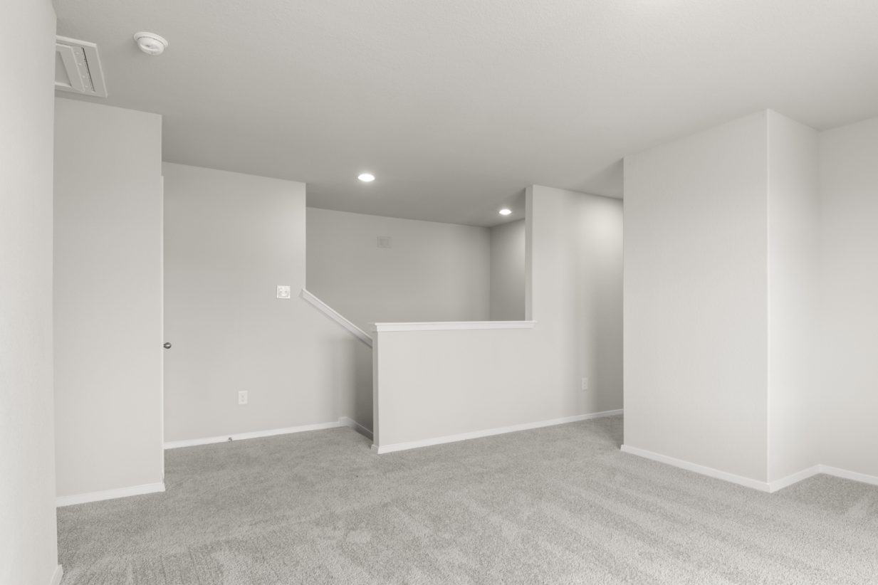 Image of upstairs flex space with light grey walls and carpet