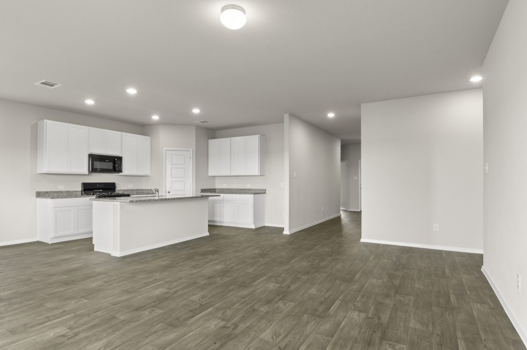 Image of a one story home living room with dark wood-like flooring and light grey walls
