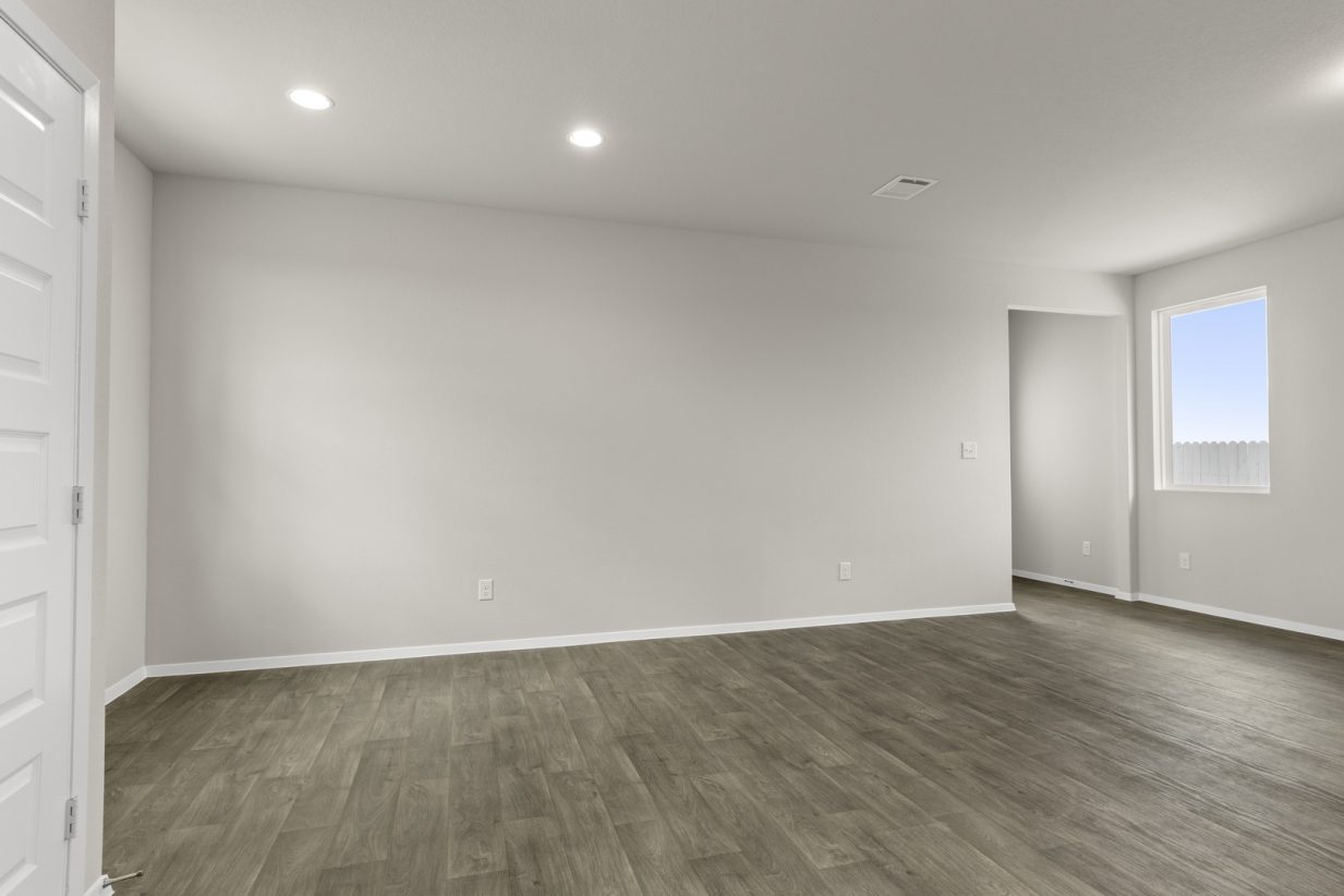Image of dining room with brown flooring and light grey walls