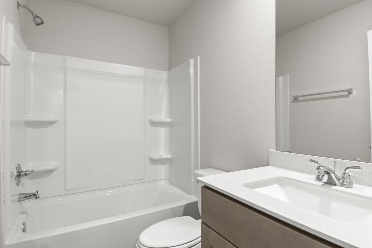 Image of bedroom with a shower and tub with a mirror and vanity