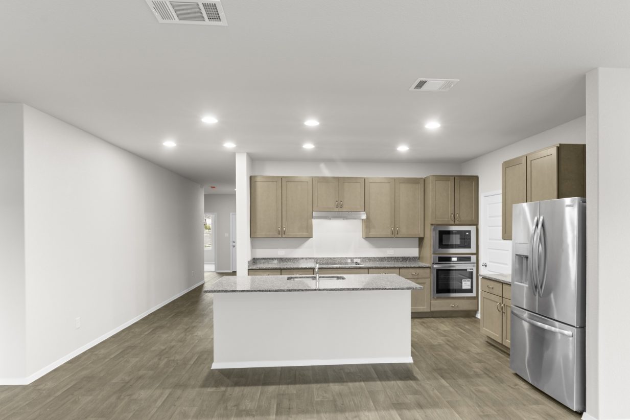 Image of a kitchen with a walkway to the front door