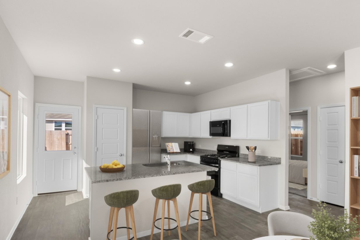 Image of a staged kitchen with green barstools, a stainless steel fridge, and a bowl of lemons on the counter