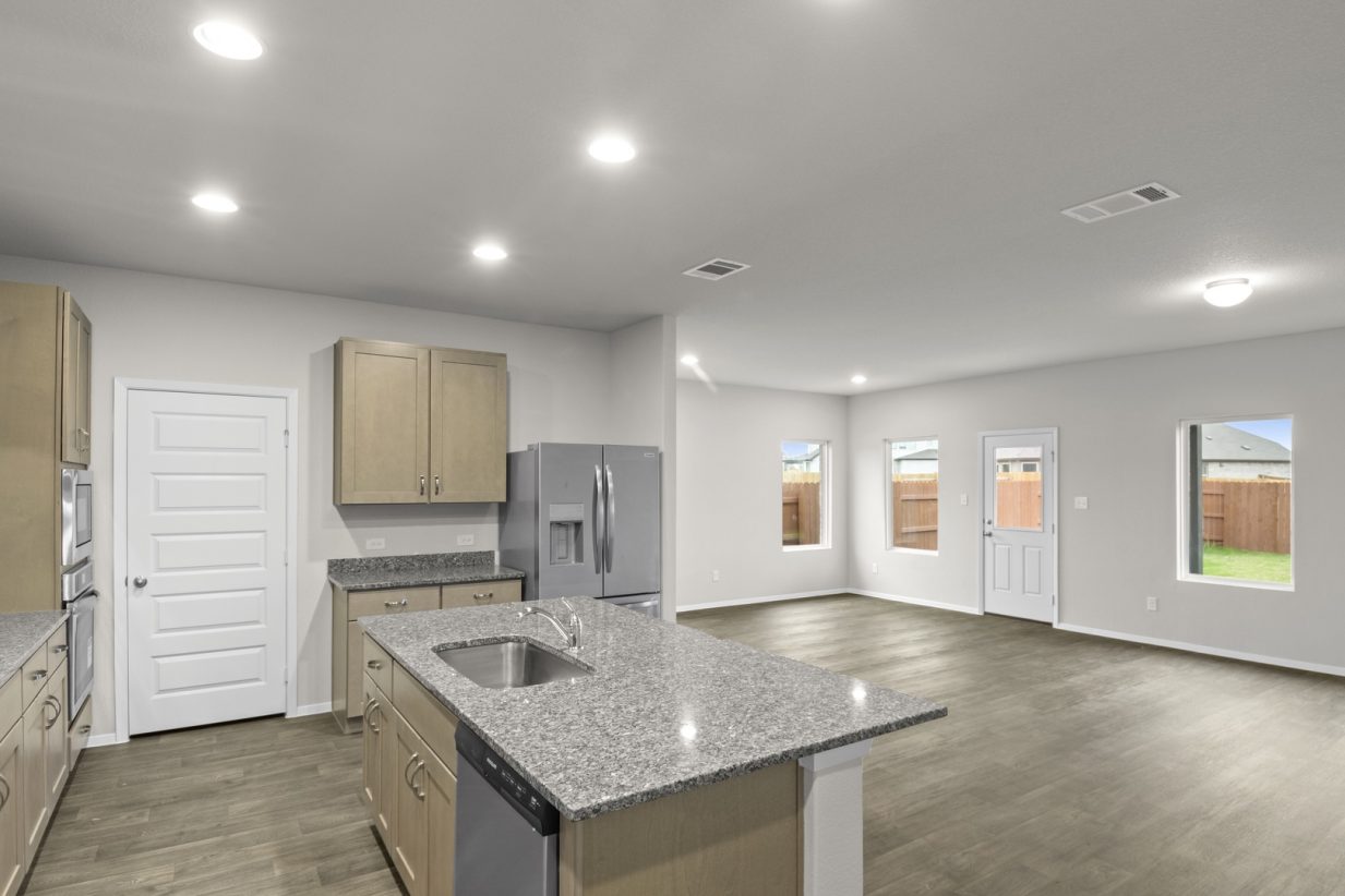 Image of a kitchen overview with a center island and a dining and living area