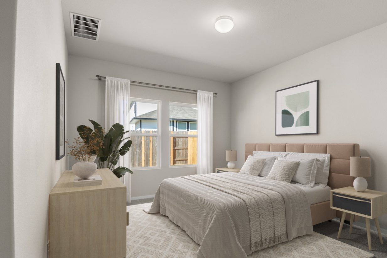 Image of a staged primary bedroom with a tan bed frame, white bedding, a light wooden dresser, and side tables with lamps