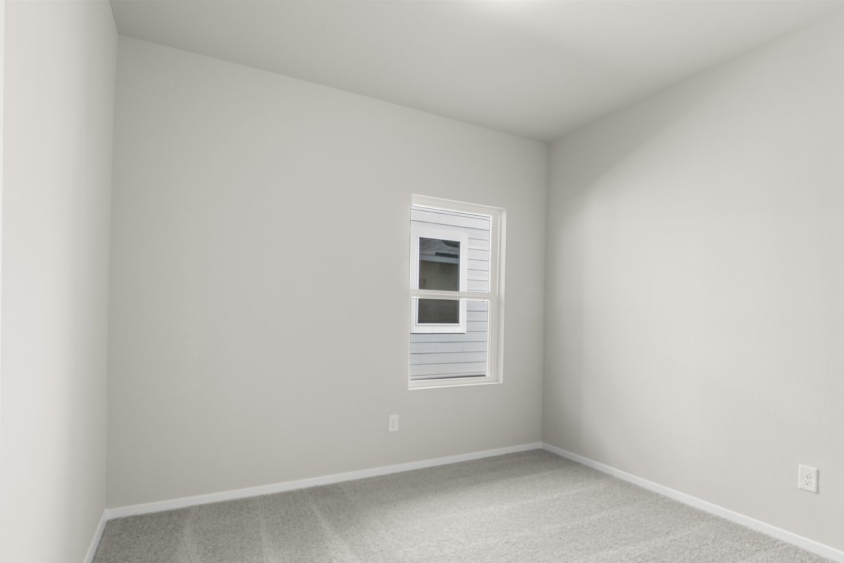 Image of a bedroom with cream walls, tan walls, white trim and a window