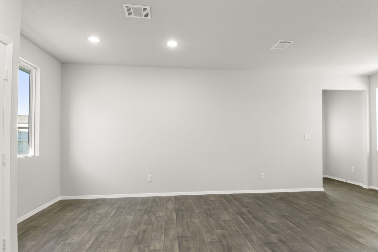 Image of a dining room area with dark vinyl, light grey walls and white trim