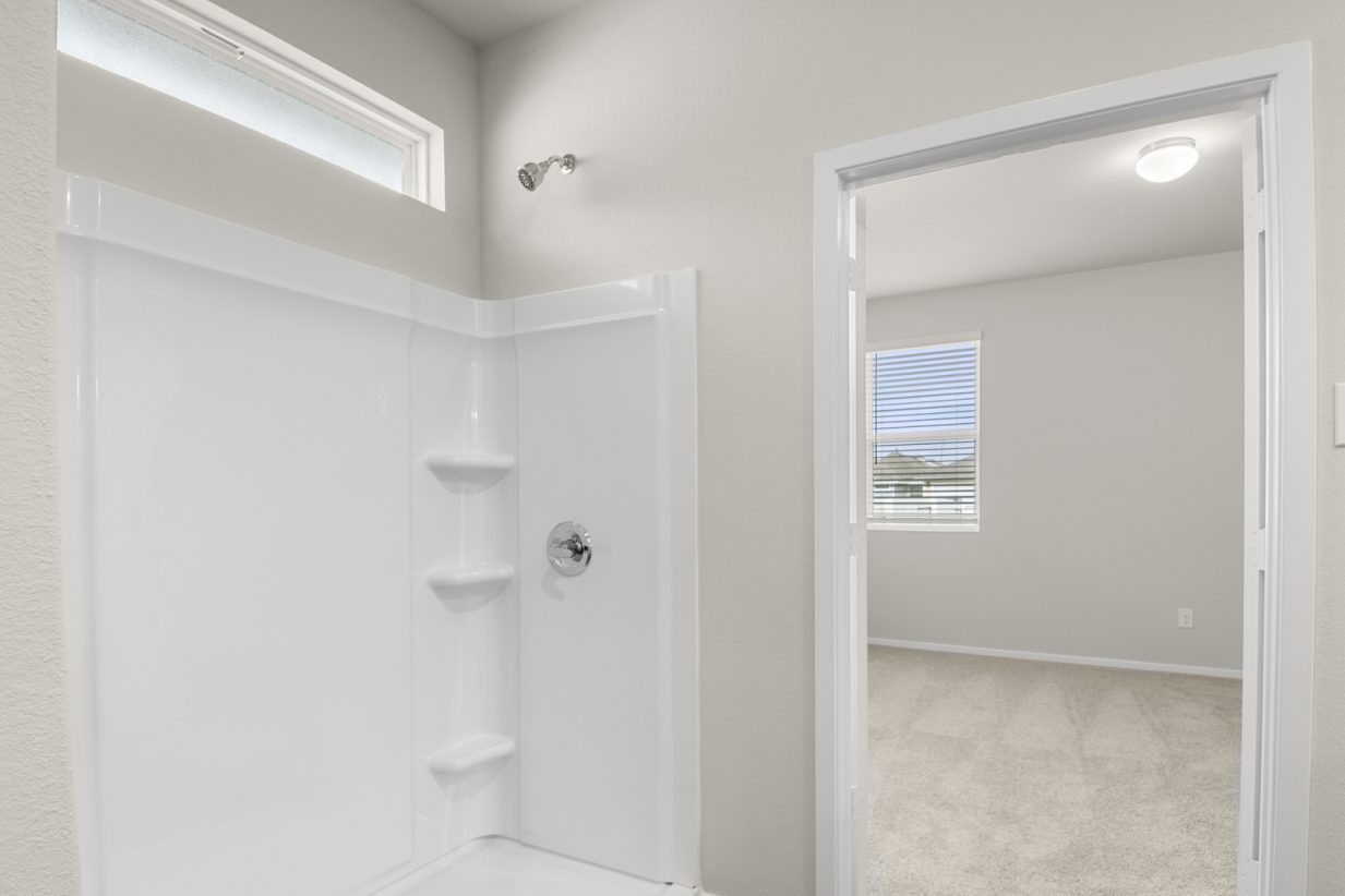 Image of a bathroom with a white vinyl walk-in shower