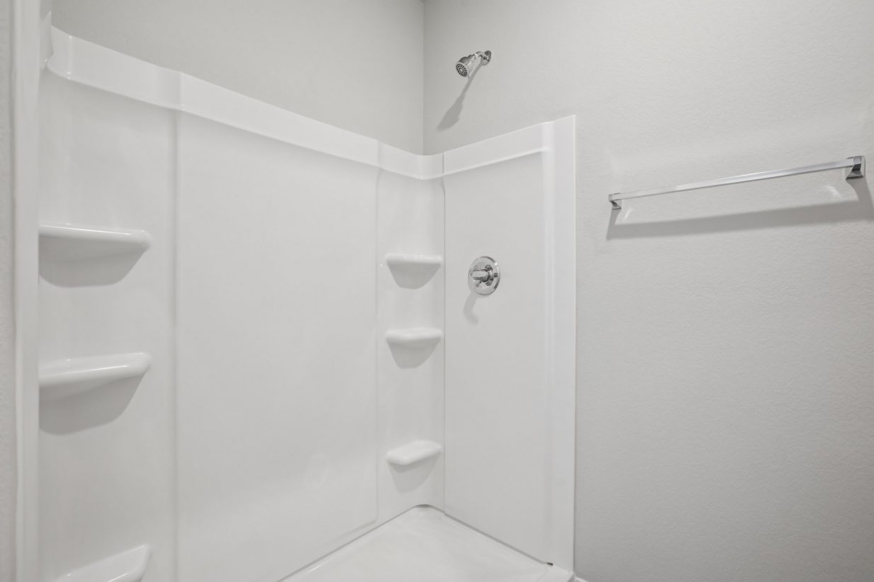 Image of a walk-in shower with white shelves