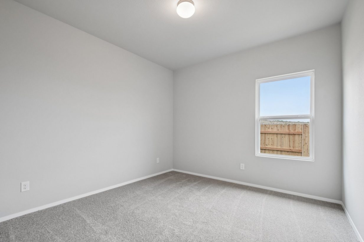 Image of a bathroom with light grey walls, tan carpeting and a window
