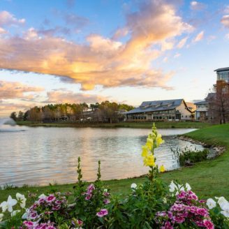 Fulshear, outdoors Green park near a lake in Fulshear, with people kayaking and relaxing in a nearby park.
