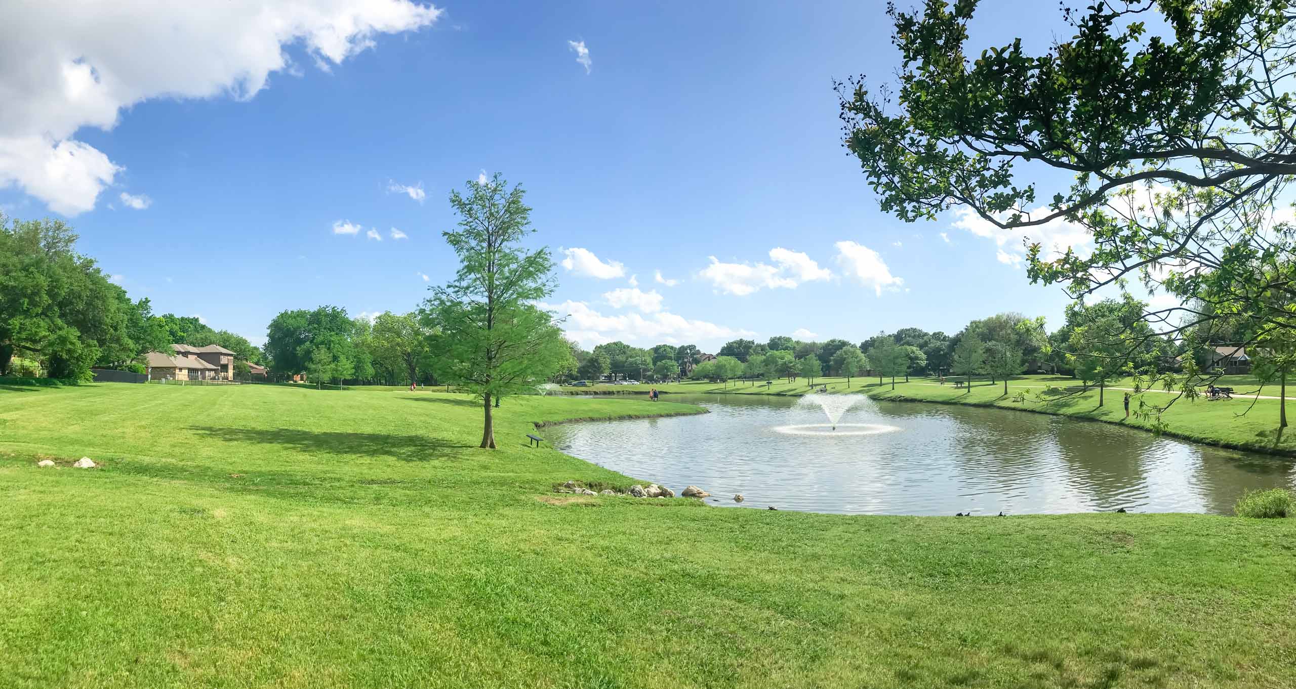 Family hiking and biking along a wooded trail near a lake close to New Caney, Texas.