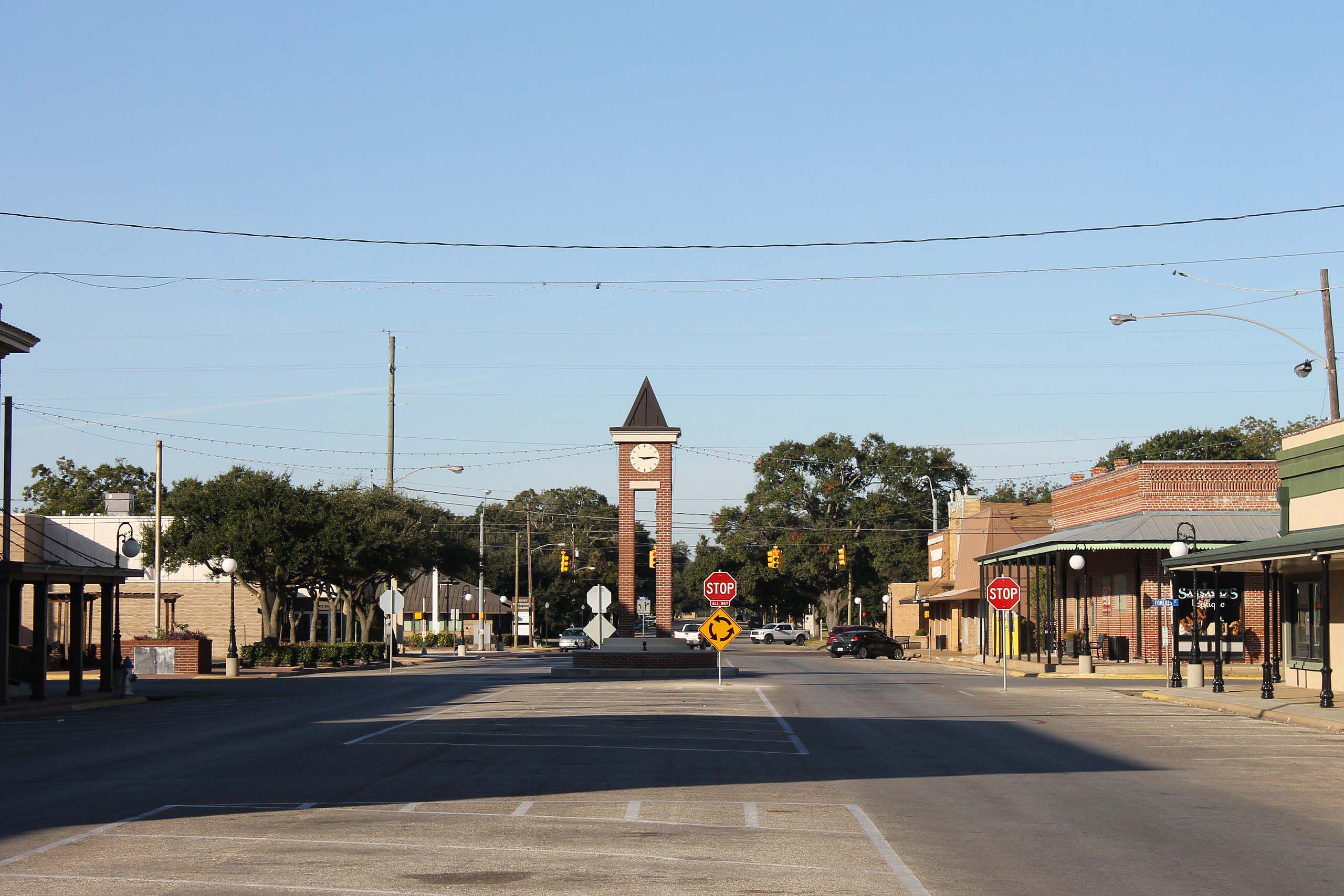 Brohn Homes new construction neighborhood in Sealy, Texas with modern homes, tree-lined streets, and historic downtown charm visible in the distance.