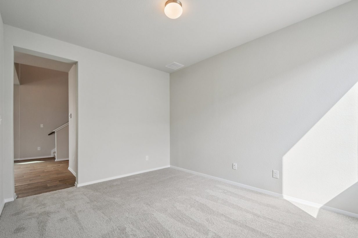 Image of a flex room with light grey walls, tan carpeting, and white trim