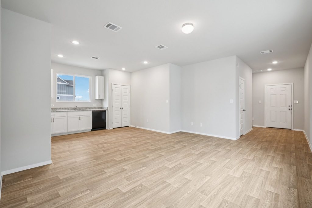 Image of a living and dining area with light brown floors