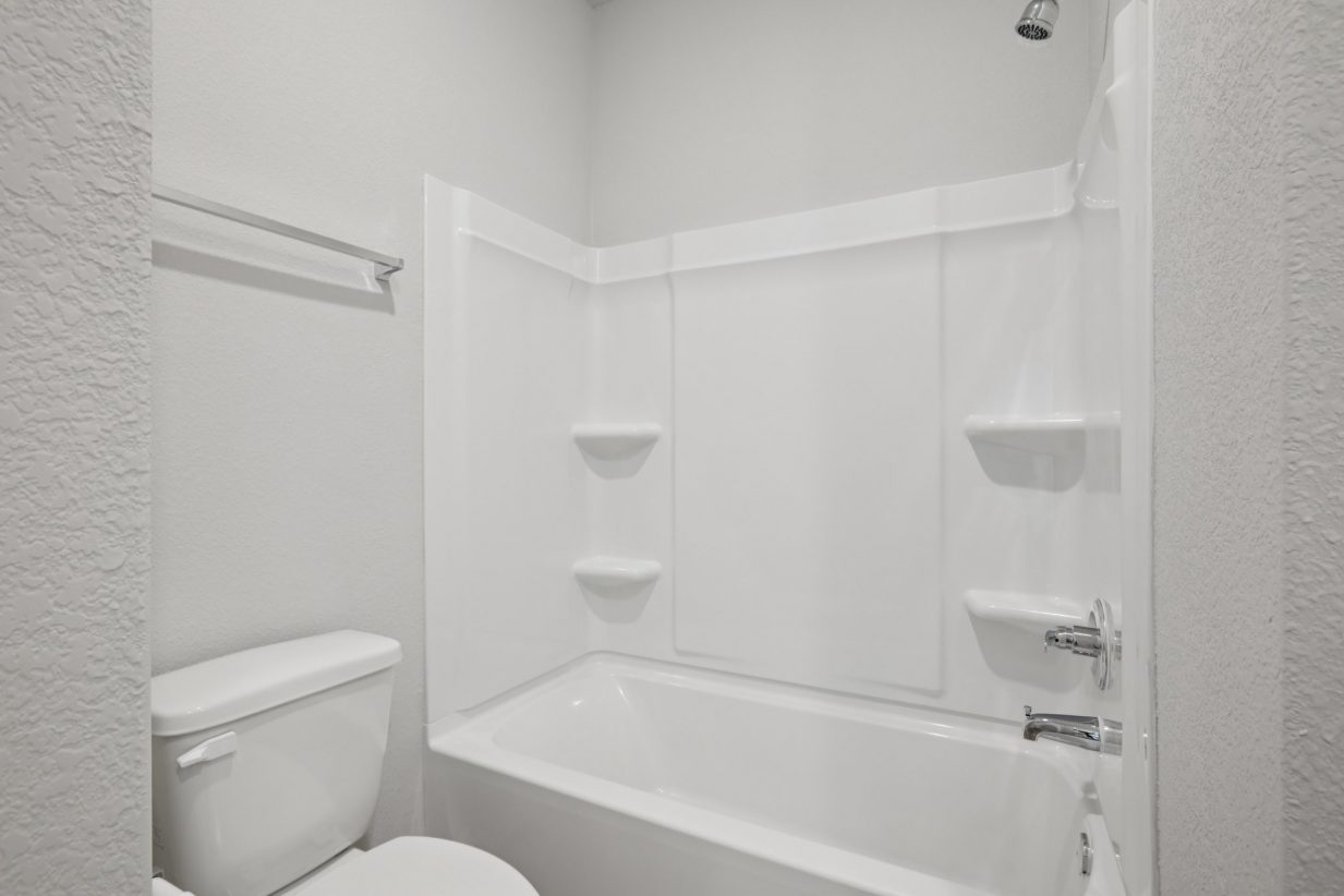 Image of a bathroom with a white shower and tub