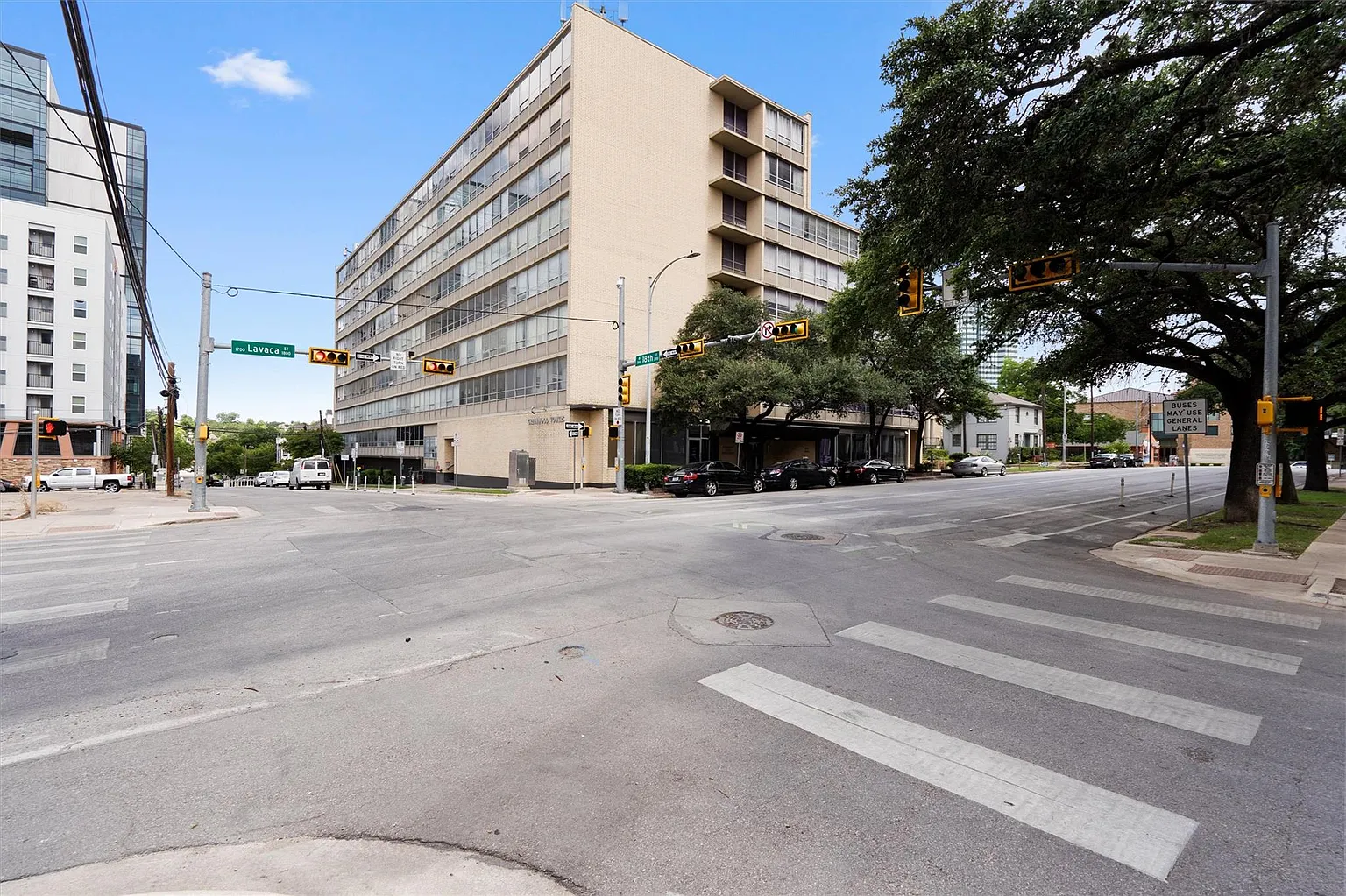A image of downtown apartment building with a blue sky background.