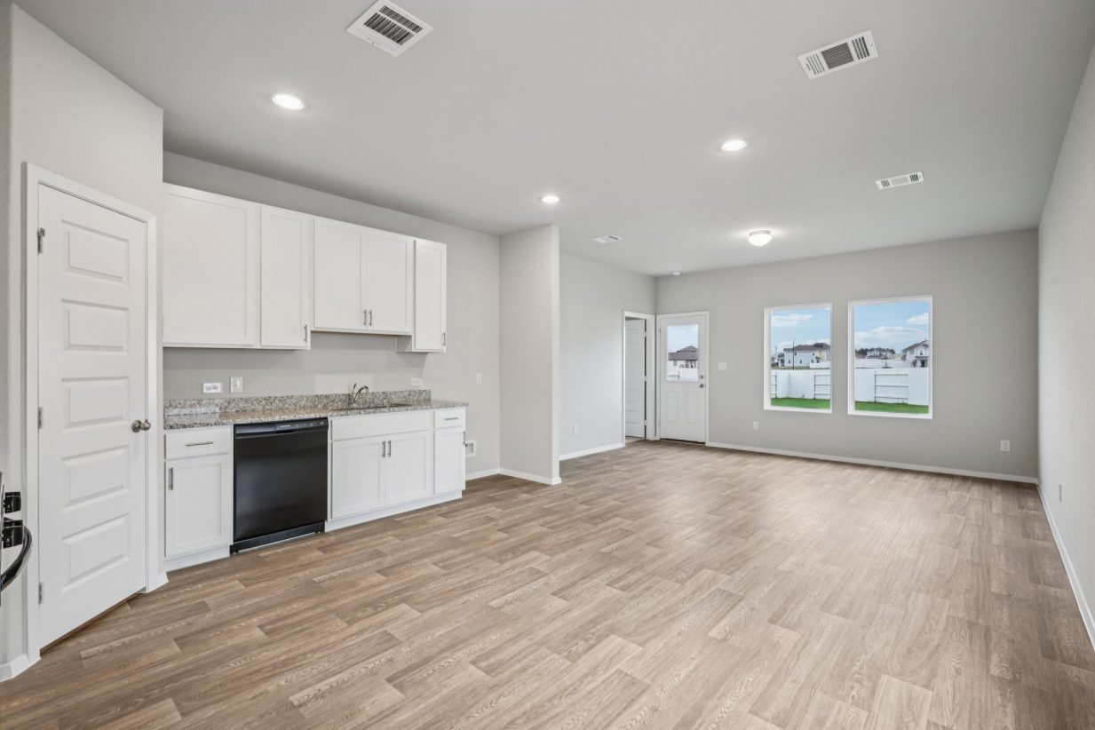 Image of a living room with vinyl flooring and grey walls