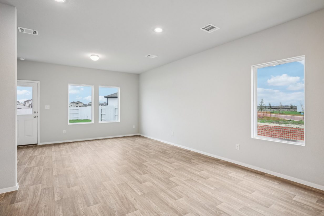 Image of a living room with vinyl flooring and grey walls