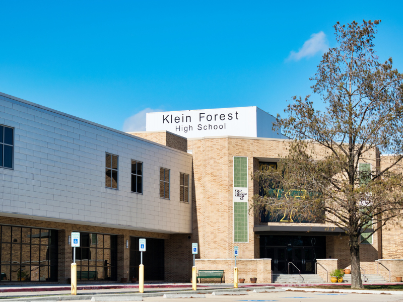Image of high school building with the words "Klein Forest" on it with a blue sky background.