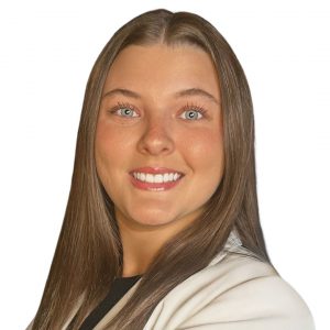 Headshot of smiling woman with long brown hair wearing a white jacket