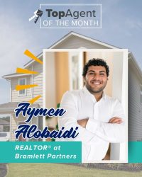A graphic of a man with a white shirt with a white frame with a background of yellow house and the words "TopAgent of the Month".