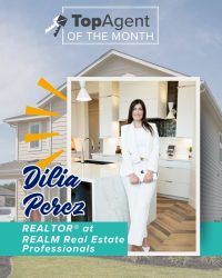A graphic of a woman with a white suit with a white frame with a background of yellow house and the words "TopAgent of the Month".