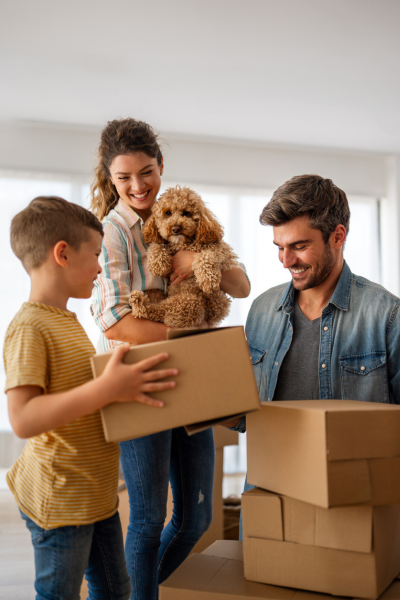 family with dog and moving boxes