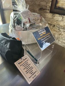 Image of 2 raffle prizes and an empty raffle box with descriptions for each